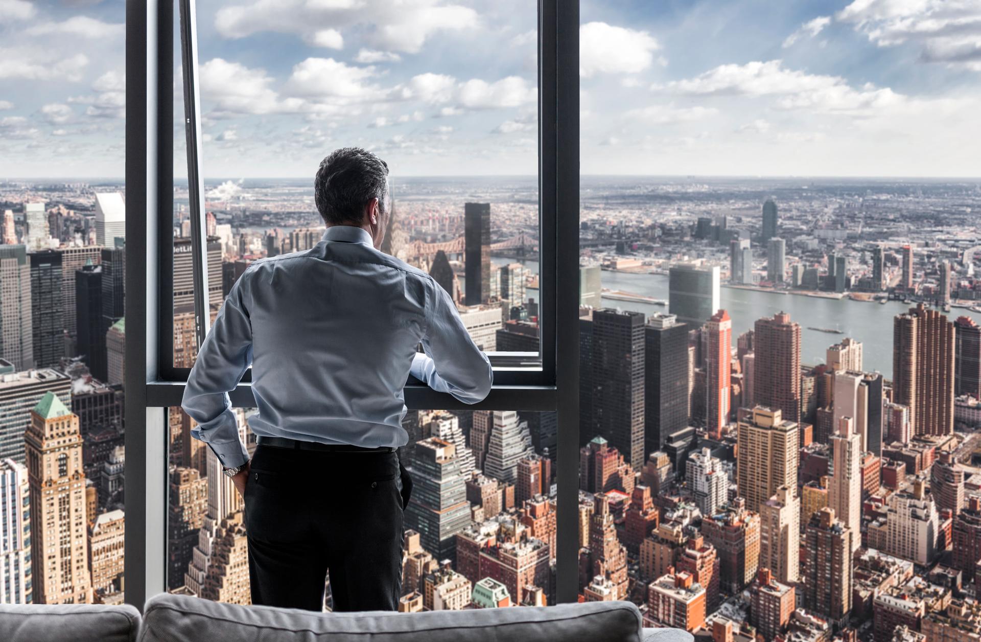 Businessman watching the city view in his office